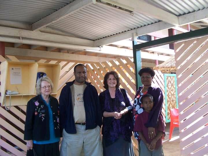 image of joshua junior kingal standing with his parents and two missionaries from the United States of America